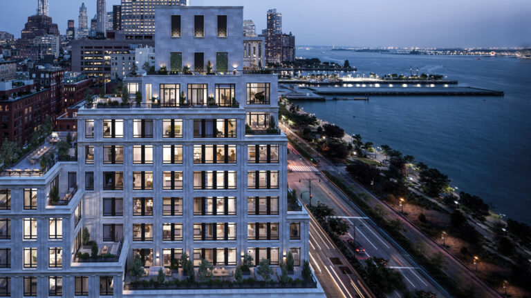 70 Vestry exterior at dusk, showing the terraced stone residential building beside the Hudson River and waterfront roadway.