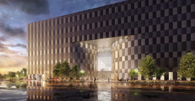 Wildflower Studios exterior rendering with a massive dark checkered facade and a dramatic illuminated central entrance at dusk.